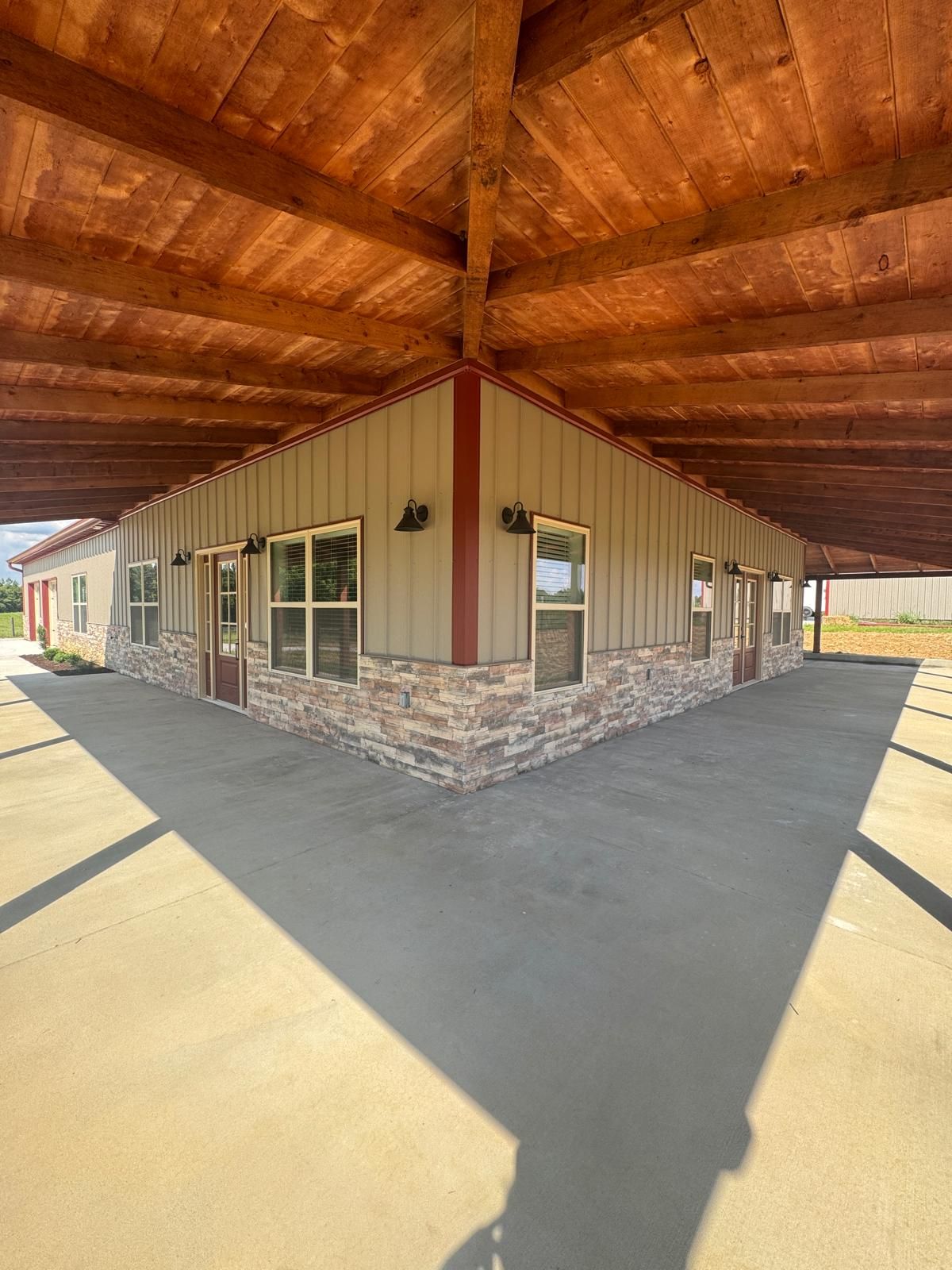 Covered porch corner with timber ceiling and stone
