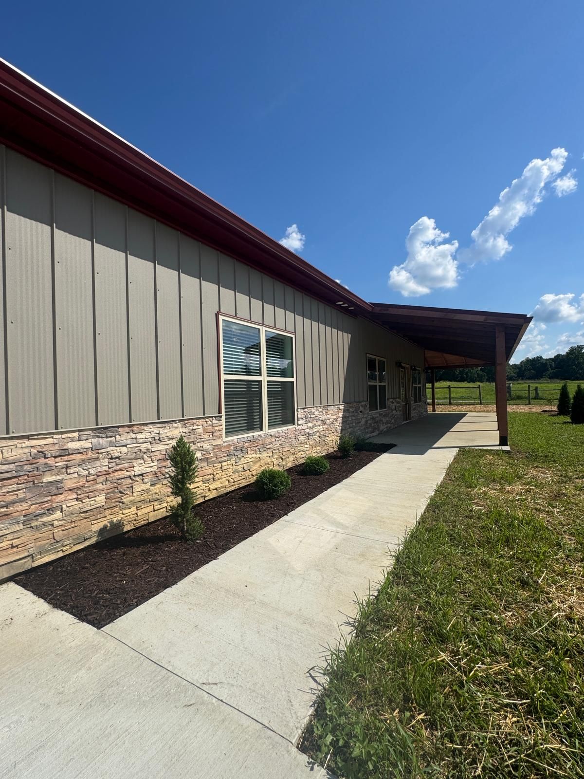 Side walkway with landscaping and stone wainscoting