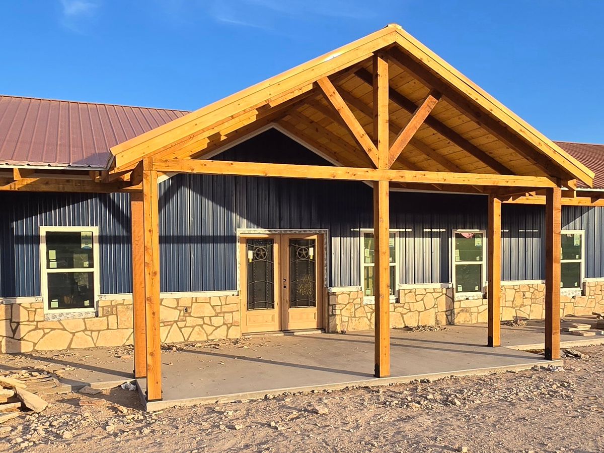Timber gable entrance with stone base — near completion