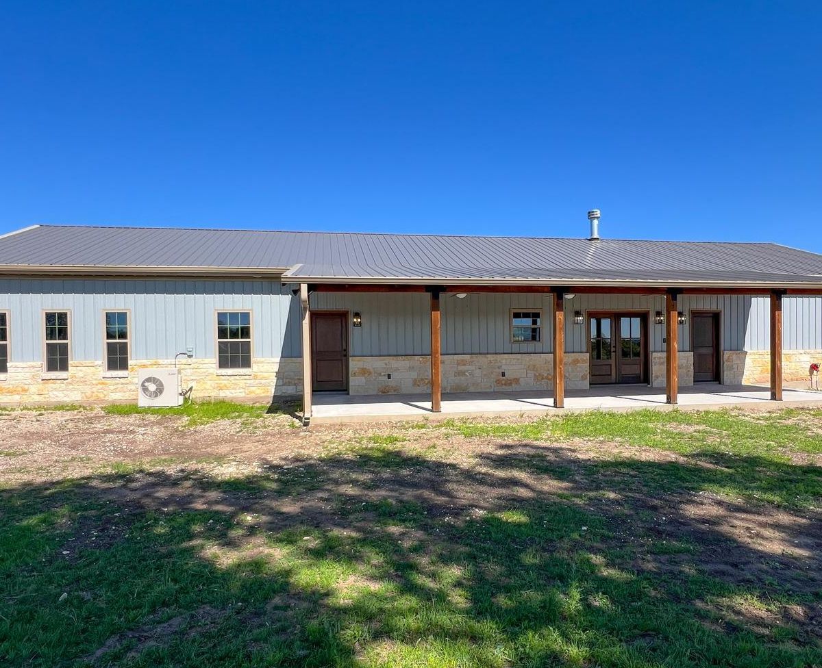 Side view showing full metal siding and porch