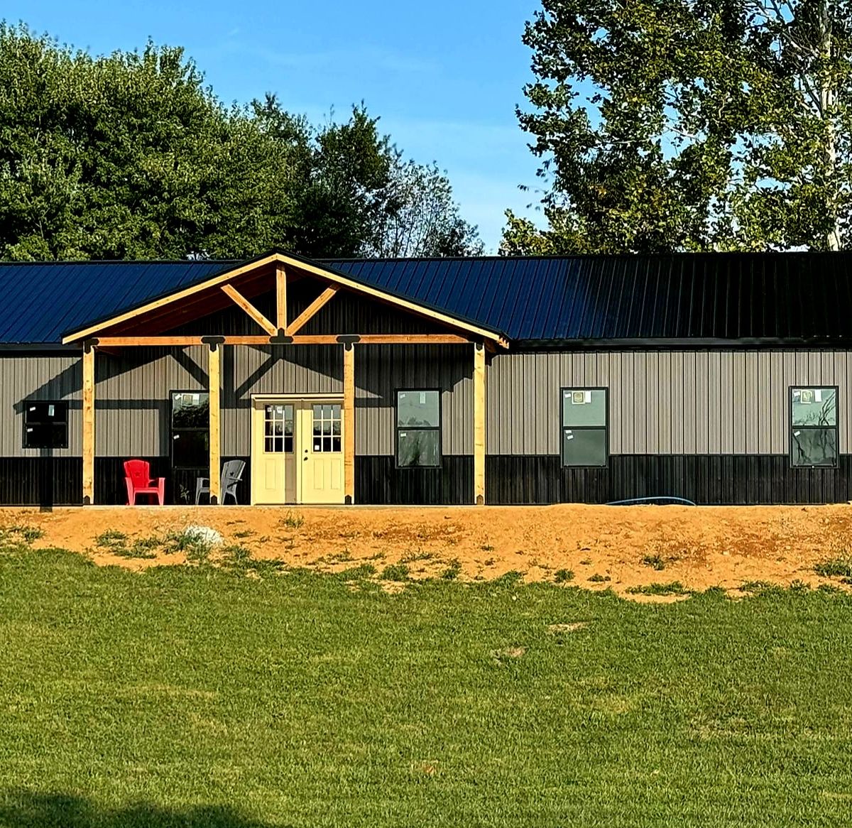 Full front view with timber gable and green lawn